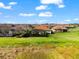 Expansive backyard view featuring lush green grass and the screened lanai of a Mediterranean style home at 10120 Carnoustie Pl, Bradenton, FL 34211