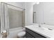 Bathroom featuring a shower-tub combo with a white vanity sink and a mirror at 10120 Carnoustie Pl, Bradenton, FL 34211