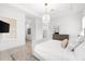 Bright bedroom features plantation shutters, a pendant light, and view of the adjoining rooms at 10120 Carnoustie Pl, Bradenton, FL 34211