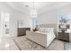 Bright bedroom with tray ceiling features a pendant light, plantation shutters, and a decorative rug at 10120 Carnoustie Pl, Bradenton, FL 34211