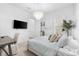 Bright bedroom featuring a decorative chandelier, tree accent, and TV at 10120 Carnoustie Pl, Bradenton, FL 34211