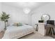 Bright bedroom featuring a decorative chandelier, tree accent, and a workspace at 10120 Carnoustie Pl, Bradenton, FL 34211