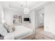 Bright bedroom features plantation shutters, a pendant light, a TV, and view of the adjoining rooms at 10120 Carnoustie Pl, Bradenton, FL 34211