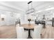 Bright dining area features wood-look tile flooring and a modern chandelier, open to the kitchen with a large island at 10120 Carnoustie Pl, Bradenton, FL 34211