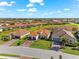 Beautiful home with a tile roof, a two-car garage, and a brick driveway with perfectly manicured landscaping at 10120 Carnoustie Pl, Bradenton, FL 34211