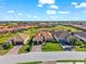 Charming home with a tile roof, two-car garage, and brick driveway in a well-manicured lawn at 10120 Carnoustie Pl, Bradenton, FL 34211