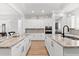 This open kitchen features dual islands, granite countertops, stainless steel appliances, and white cabinetry at 10120 Carnoustie Pl, Bradenton, FL 34211