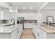 This kitchen features dual islands, granite countertops, stainless steel appliances, and white cabinetry at 10120 Carnoustie Pl, Bradenton, FL 34211