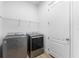 Modern laundry room featuring side by side washer and dryer at 10120 Carnoustie Pl, Bradenton, FL 34211