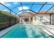 Beautiful screened pool area featuring an in-ground pool and spa, with a spacious patio and covered outdoor seating at 10120 Carnoustie Pl, Bradenton, FL 34211