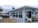 Exterior view of the house, showing light blue siding and white accents at 10315 Cortez W Rd # 58-3, Bradenton, FL 34210