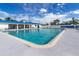 Inviting community swimming pool with plenty of lounge chairs at 10315 Cortez W Rd # 58-3, Bradenton, FL 34210