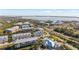 Aerial view of waterfront community with upscale townhouses and lush landscaping at 10390 Longshore Rd # 83, Placida, FL 33946