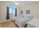 Bright bedroom with two twin beds and large arched window at 10390 Longshore Rd # 83, Placida, FL 33946