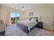 Spacious main bedroom with king-size bed and access to balcony at 10390 Longshore Rd # 83, Placida, FL 33946