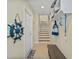 Mudroom with bench, shelves, nautical decor, and stairs at 10390 Longshore Rd # 83, Placida, FL 33946