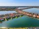 Stunning aerial view of lakeside homes with terracotta roofs in a well-maintained, planned community at 109 Porta Vecchio Bnd # 202, Nokomis, FL 34275