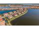 Scenic aerial view of homes on a lake with mature landscaping, tile roofs, and a lush community at 109 Porta Vecchio Bnd # 202, Nokomis, FL 34275