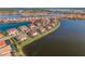 Scenic aerial view of homes on a lake with mature landscaping, tile roofs, and a lush community at 109 Porta Vecchio Bnd # 202, Nokomis, FL 34275