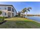 Beautiful backyard with lush green grass and a serene view of the lake, perfect for relaxation at 109 Porta Vecchio Bnd # 202, Nokomis, FL 34275