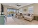 Bright living room with comfortable seating, sliding glass doors leading to outdoor balcony area at 109 Porta Vecchio Bnd # 202, Nokomis, FL 34275