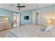 Airy bedroom with a king bed, TV, ceiling fan, and doorway to the living room and ensuite bathroom at 109 Porta Vecchio Bnd # 202, Nokomis, FL 34275