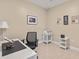 Functional home office with a large desk, comfortable chair, and ample lighting at 109 Porta Vecchio Bnd # 202, Nokomis, FL 34275