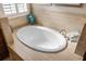 Relaxing bathroom with oval soaking tub and tile at 110 Asti Ct, North Venice, FL 34275