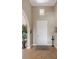 Light and airy entryway with tile floors and a simple door at 110 Asti Ct, North Venice, FL 34275