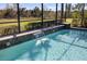 Relaxing pool area with a waterfall feature and screened enclosure at 110 Asti Ct, North Venice, FL 34275