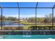 Pool with water feature and scenic view of lake and homes at 110 Asti Ct, North Venice, FL 34275