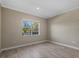 Simple bedroom with large window and neutral wall colors at 12029 Perennial Pl, Bradenton, FL 34211