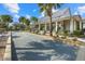 Bocce ball court in front of a building with landscaping and palm trees under a blue sky at 12029 Perennial Pl, Lakewood Ranch, FL 34211