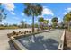 Bocce ball court near a sand volleyball court, benches, landscaping, palm trees, and nearby homes at 12029 Perennial Pl, Lakewood Ranch, FL 34211