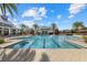 Community pool featuring marked lanes for swimming, tropical landscaping, and ample space for lounging at 12029 Perennial Pl, Lakewood Ranch, FL 34211