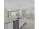 Modern kitchen with large island, white cabinets, and granite countertops at 12029 Perennial Pl, Bradenton, FL 34211