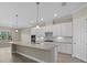 Modern kitchen with large island, white cabinets, and granite countertops at 12029 Perennial Pl, Bradenton, FL 34211