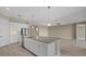 Modern kitchen with large island, white cabinets, and granite countertops at 12029 Perennial Pl, Lakewood Ranch, FL 34211