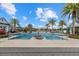 A large community pool with lounge chairs and umbrellas for shade at 12029 Perennial Pl, Lakewood Ranch, FL 34211