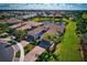 Aerial view showcases this beautiful home, its surrounding landscape and pond at 12251 Myrtle Bay Ct, Sarasota, FL 34238