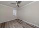 Bright bedroom featuring wood-look flooring and a window with shutters at 12251 Myrtle Bay Ct, Sarasota, FL 34238