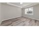 Well-lit bedroom showcasing wood-look flooring and neutral tones at 12251 Myrtle Bay Ct, Sarasota, FL 34238