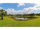 Community with pond, lush landscaping and homes at 12251 Myrtle Bay Ct, Sarasota, FL 34238