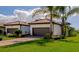 Two-car garage, brick pavers, and lush landscaping highlight this home's exterior at 12251 Myrtle Bay Ct, Sarasota, FL 34238