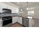 Modern kitchen with stainless steel appliances and granite countertops at 12251 Myrtle Bay Ct, Sarasota, FL 34238