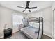 Cozy bedroom showcasing a twin bunk bed, ceiling fan, and bright natural light at 1259 39Th St, Sarasota, FL 34234