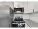 Modern kitchen featuring stainless steel appliances and speckled granite countertops at 1259 39Th St, Sarasota, FL 34234