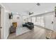 Bright living room features a large window, sleek ceiling fan, and stylish gray sofa with soft carpet at 1259 39Th St, Sarasota, FL 34234