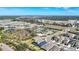 Aerial view of a residential community with houses, a pool, and green spaces at 15305 Isla Palma Ln, Nokomis, FL 34275