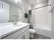 Bathroom with white vanity, bathtub, and gray tile floor at 15305 Isla Palma Ln, Nokomis, FL 34275